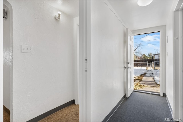 entryway featuring dark colored carpet