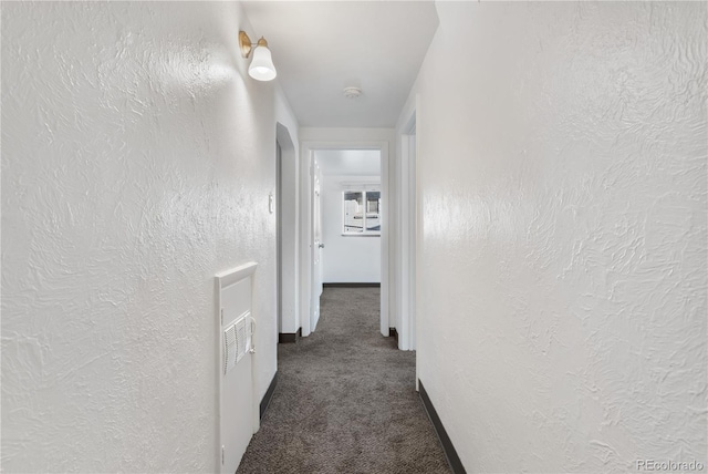 hallway with dark carpet