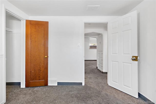 unfurnished bedroom featuring dark colored carpet