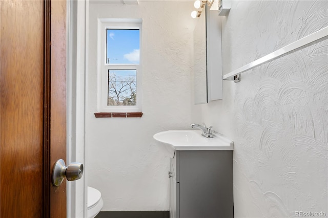 bathroom featuring vanity and toilet