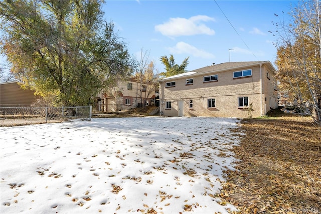 view of snow covered rear of property