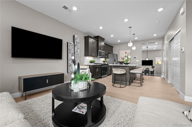 9445 W 58th Cir Unit B, Arvada, CO 80002 - living room featuring recessed lighting and light wood-style flooring