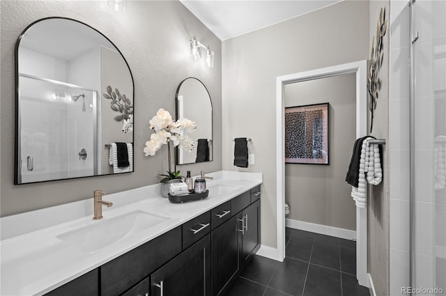 9445 W 58th Cir Unit B, Arvada, CO 80002 - bathroom with double vanity, tile patterned flooring, and tiled shower
