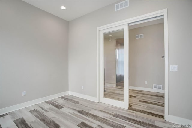 unfurnished room featuring light hardwood / wood-style floors