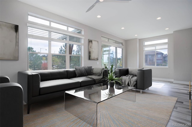 living room featuring hardwood / wood-style floors, ceiling fan, and plenty of natural light