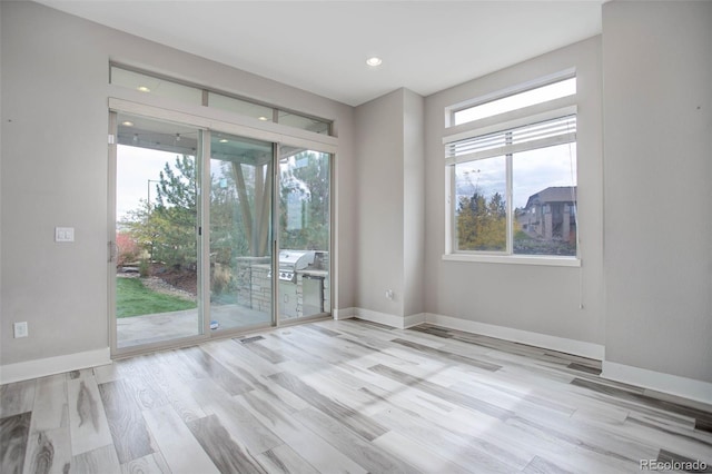 empty room with light hardwood / wood-style floors