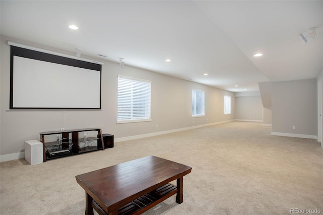 carpeted cinema room featuring lofted ceiling