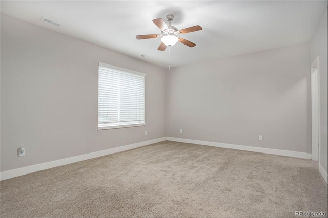 unfurnished room with light colored carpet and ceiling fan