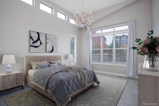 carpeted bedroom featuring an inviting chandelier and vaulted ceiling