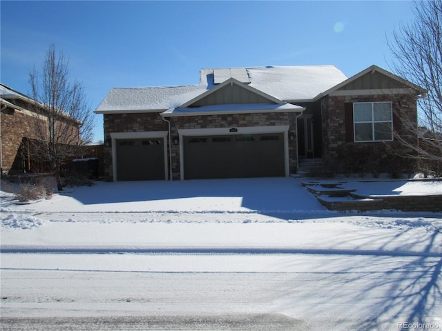 view of front facade featuring a garage and stone siding