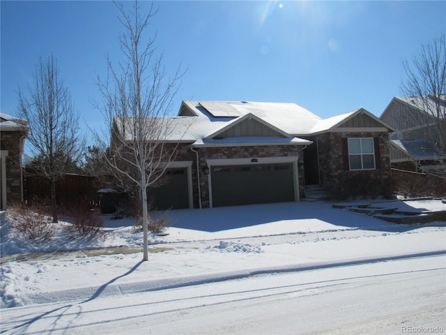 view of front of home with a garage and stone siding