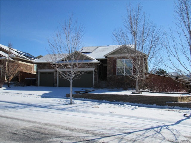 view of front of house featuring a garage and stone siding