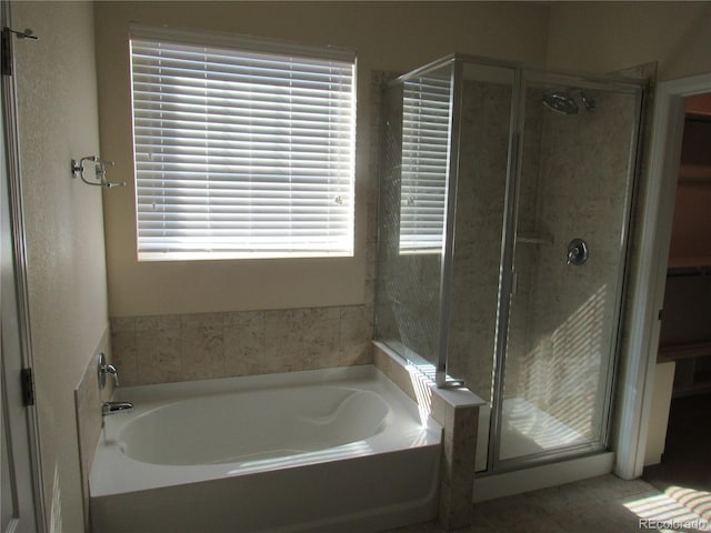 bathroom with a garden tub and a shower stall