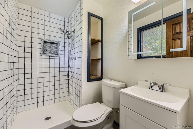 16293 E Brown Pl, Aurora, CO 80013 - bathroom featuring a shower stall, toilet, vanity, and a textured wall