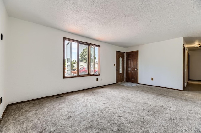 16293 E Brown Pl, Aurora, CO 80013 - spare room with a textured ceiling, carpet flooring, and baseboards