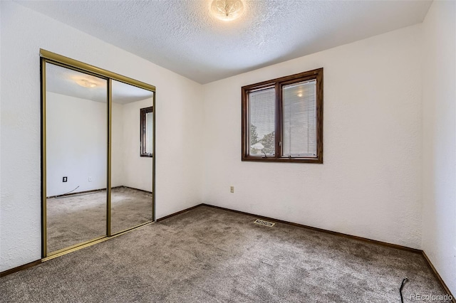 16293 E Brown Pl, Aurora, CO 80013 - unfurnished bedroom featuring carpet flooring, baseboards, a closet, and a textured ceiling
