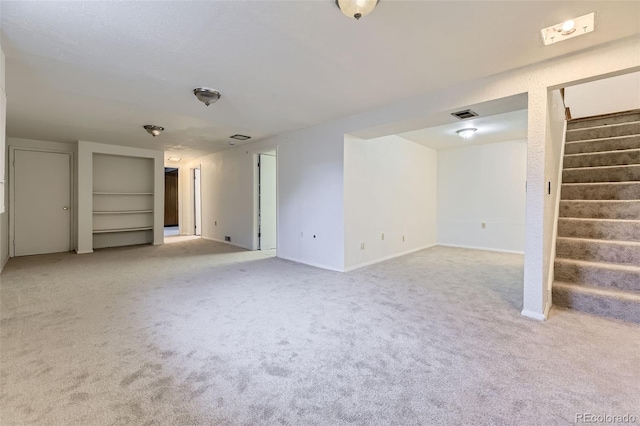 16293 E Brown Pl, Aurora, CO 80013 - unfurnished living room with light carpet, stairs, and baseboards