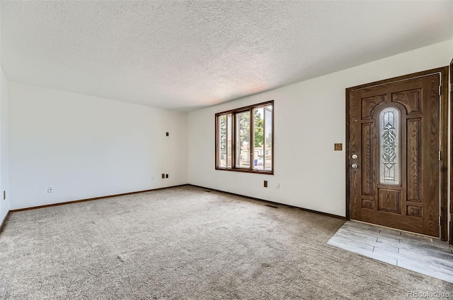 16293 E Brown Pl, Aurora, CO 80013 - carpeted entryway with a textured ceiling and baseboards