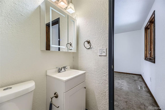 16293 E Brown Pl, Aurora, CO 80013 - half bath featuring vanity, toilet, and a textured wall