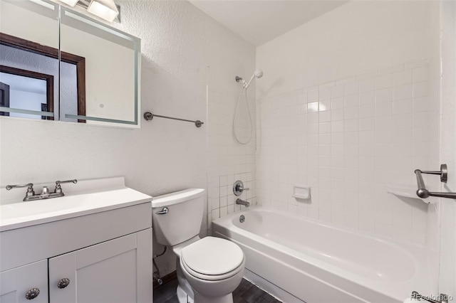16293 E Brown Pl, Aurora, CO 80013 - full bath featuring vanity, toilet, tub / shower combination, wood finished floors, and a textured wall