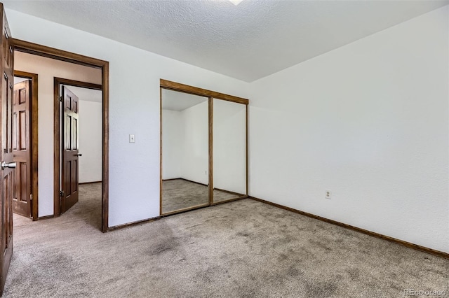16293 E Brown Pl, Aurora, CO 80013 - unfurnished bedroom with carpet flooring, baseboards, a closet, and a textured ceiling