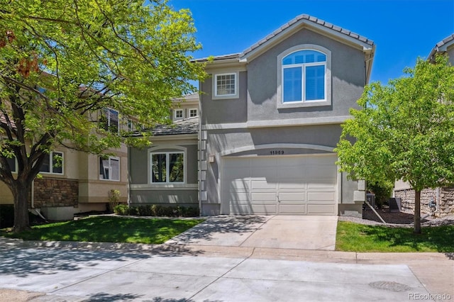 11969 E Lake Cir, Greenwood Village, CO 80111 - traditional home featuring stucco siding, an attached garage, and concrete driveway