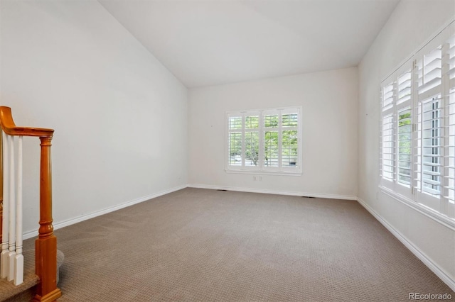 11969 E Lake Cir, Greenwood Village, CO 80111 - carpeted spare room with healthy amount of natural light, lofted ceiling, and baseboards
