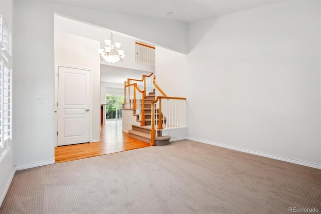 11969 E Lake Cir, Greenwood Village, CO 80111 - carpeted spare room featuring a chandelier, stairs, and baseboards