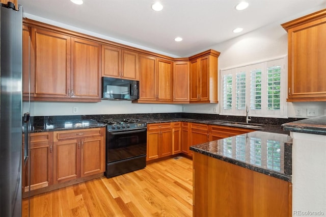 11969 E Lake Cir, Greenwood Village, CO 80111 - kitchen featuring black appliances, a sink, light wood-style floors, brown cabinets, and recessed lighting