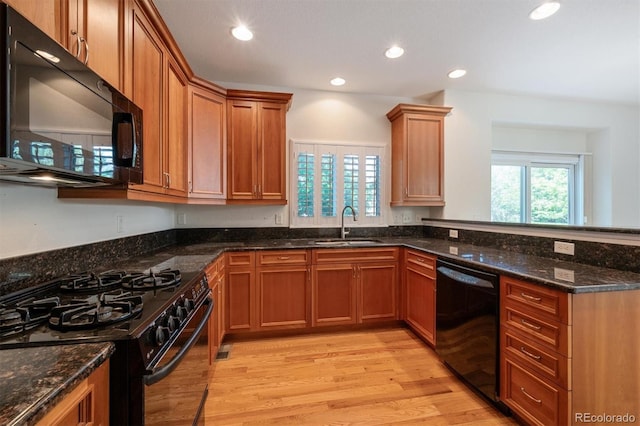 11969 E Lake Cir, Greenwood Village, CO 80111 - kitchen with black appliances, a sink, healthy amount of natural light, dark stone countertops, and recessed lighting