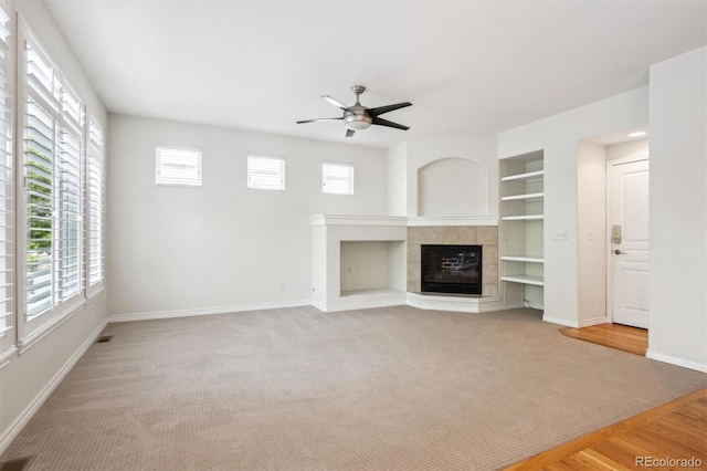 11969 E Lake Cir, Greenwood Village, CO 80111 - unfurnished living room featuring carpet, healthy amount of natural light, ceiling fan, and a fireplace