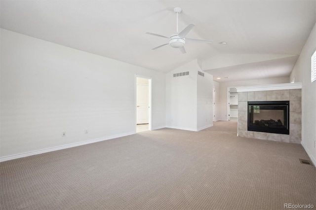 11969 E Lake Cir, Greenwood Village, CO 80111 - unfurnished living room featuring a ceiling fan, vaulted ceiling, carpet, a tile fireplace, and baseboards