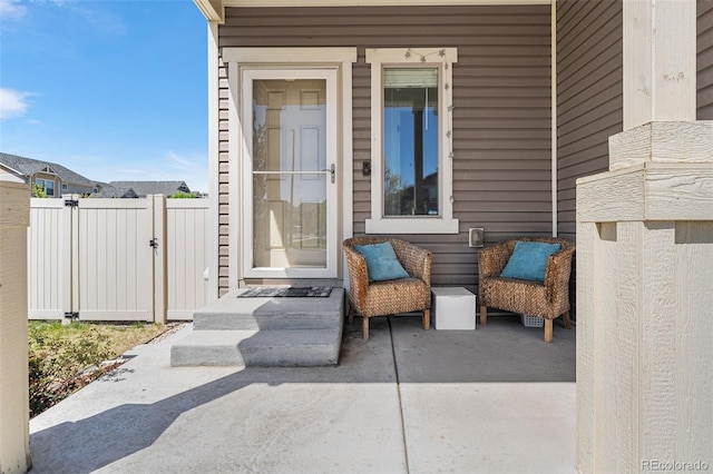 4405 Walden Ct, Denver, CO 80249 - view of exterior entry with fence, a gate, and a patio area