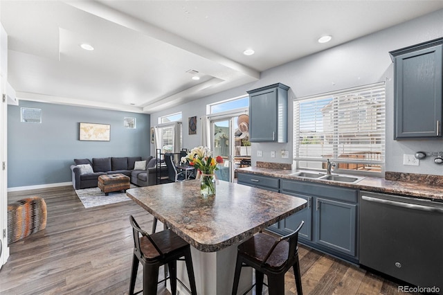 4405 Walden Ct, Denver, CO 80249 - kitchen with dishwasher, dark countertops, a kitchen breakfast bar, dark wood-type flooring, and open floor plan