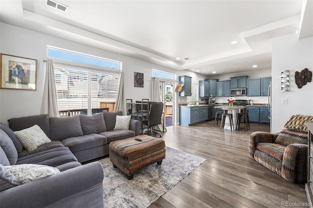 4405 Walden Ct, Denver, CO 80249 - living area featuring a raised ceiling, recessed lighting, and dark wood-style flooring