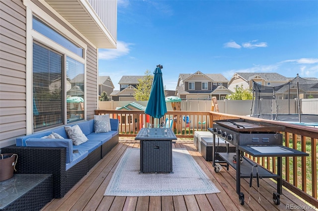4405 Walden Ct, Denver, CO 80249 - deck featuring outdoor lounge area, a trampoline, a residential view, and fence
