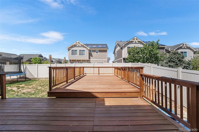 4405 Walden Ct, Denver, CO 80249 - wooden terrace featuring a trampoline and a residential view