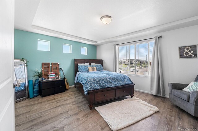 4405 Walden Ct, Denver, CO 80249 - bedroom featuring wood finished floors, multiple windows, and baseboards