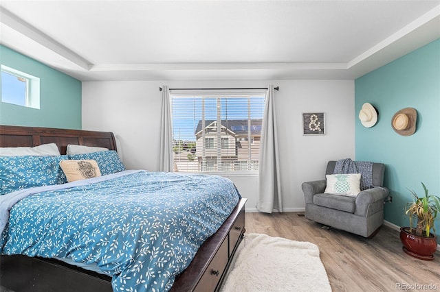 4405 Walden Ct, Denver, CO 80249 - bedroom featuring light wood finished floors, a raised ceiling, and baseboards