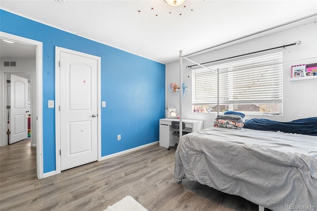 4405 Walden Ct, Denver, CO 80249 - bedroom featuring wood finished floors and baseboards
