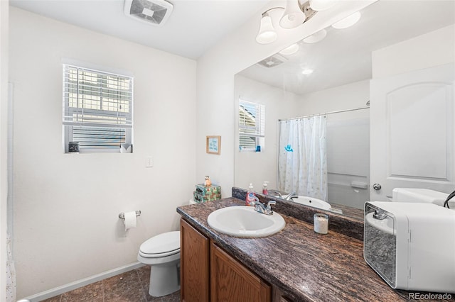 4405 Walden Ct, Denver, CO 80249 - full bathroom featuring toilet, baseboards, curtained shower, and vanity