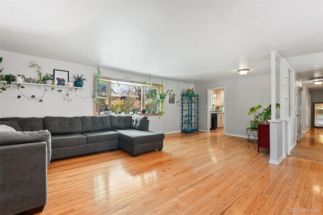 living area with baseboards and light wood-style floors