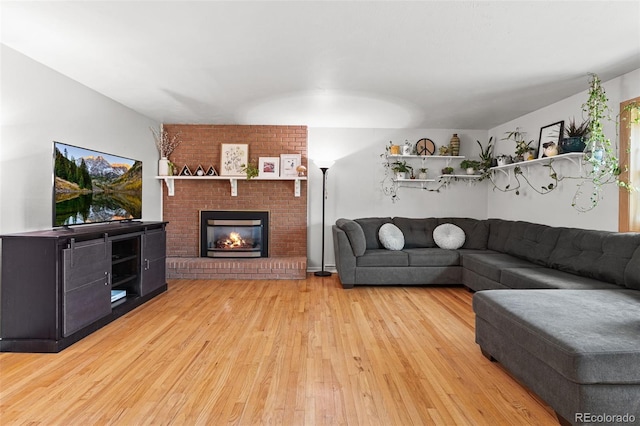 living area with a fireplace and light wood-style floors