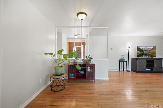 interior space with wood finished floors and baseboards