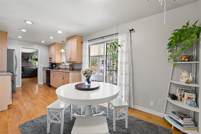 dining area with light wood-type flooring, baseboards, and recessed lighting
