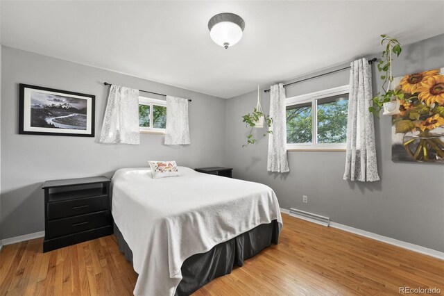 bedroom featuring wood finished floors, visible vents, and baseboards
