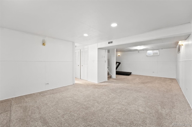 below grade area with visible vents, carpet flooring, recessed lighting, and stairway