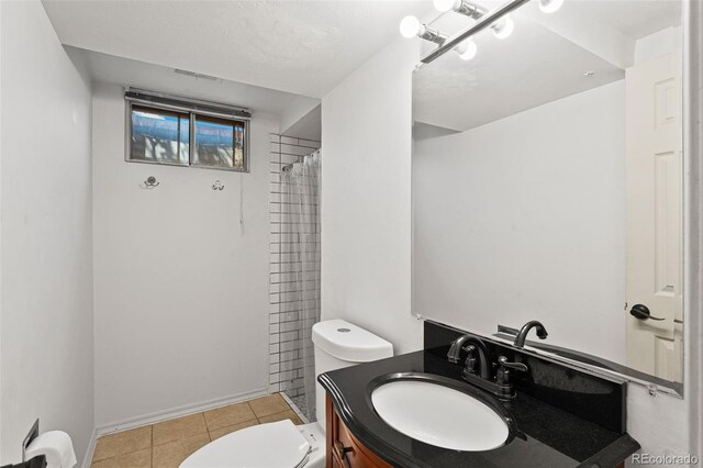 bathroom featuring a shower with curtain, vanity, tile patterned flooring, and toilet