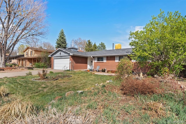 single story home with an attached garage, brick siding, a front yard, and concrete driveway