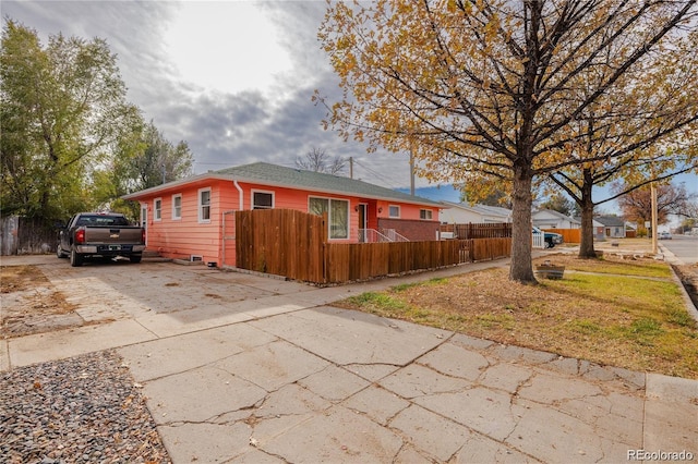 612 W Bijou Ave, Fort Morgan, CO 80701 - view of side of home with concrete driveway and a fenced front yard